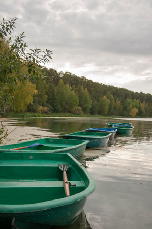 Group of traditional rowing boats moored to the pierの写真素材