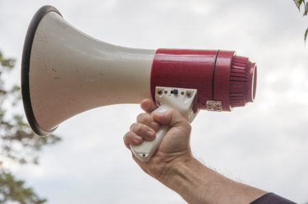 Megaphone in activist, leader's hand. Prepare to announce. concept : equipment for speaking to make...