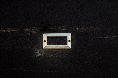 blank metal nameplate or name-board on black backgroundの写真素材
