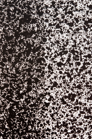 Splattered pf black ink drops on white backgroundの写真素材