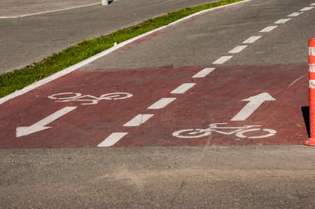 Red bicycle path on which a bicycle passes close-upの写真素材