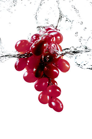 Bunch of red grapes with water splash isolated on white background.の素材