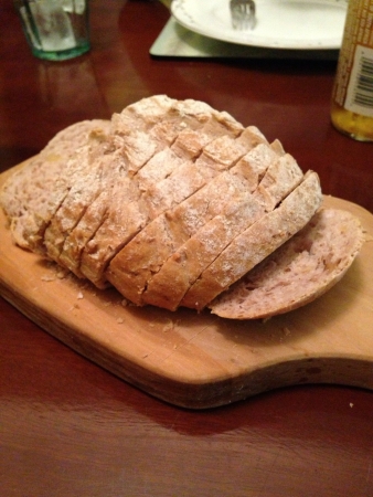 A loaf of bread on an olive wood boardの素材