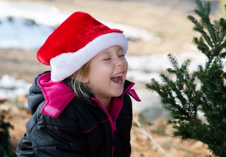 laughing girl in a santa hatの写真素材