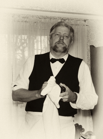 old fashioned bartender dries a glass  with a towel の写真素材