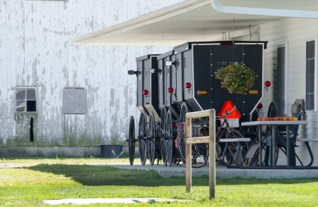 Amish buggies lined up outside a barnの写真素材