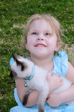 a adorable little girl looks hopefully up at mom  please can we keep him の写真素材