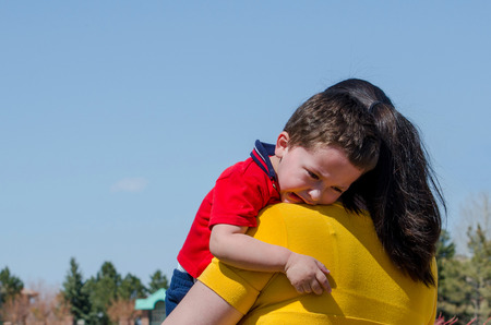 mom hugs her sad child and consoles himの写真素材