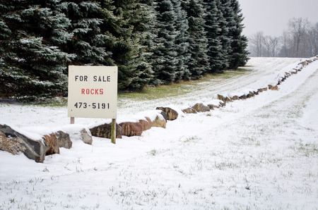A landscaper has large rocks for sale, even in the snowの写真素材