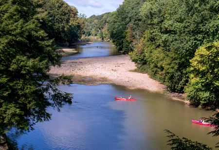 People have fun paddling canoes down the river at turkey run state park in Indianaの写真素材