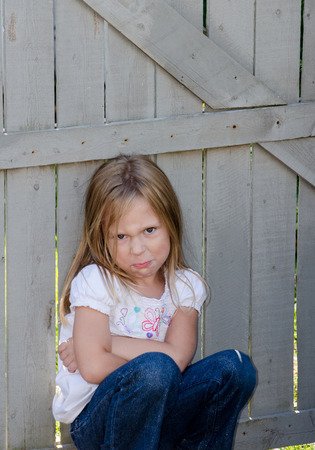 A little girl is a bit unhappy and has a angry attitude