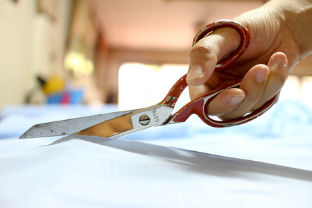 Dressmaker cutting fabric