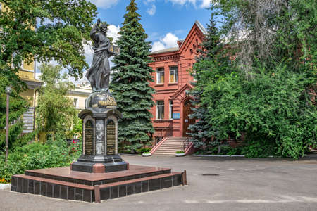 Kharkiv, Ukraine - July 20, 2020: Jesus Christ statue with a book in front of Theological Seminary...