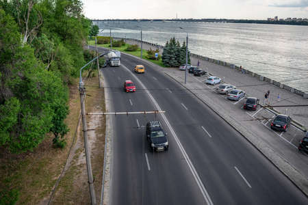 Dnipro, Ukraine - July 21, 2020: Top view of the highway with cars along the Sicheslavskaya embankment in Dnipro. Cityscape with  a street against the background of the silvery water of Dnieper riverのeditorial素材