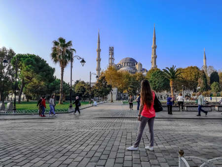 Istanbul, Turkey - October 29, 2019: Tourists in Sultanahmet Square against the background of Blue Mosque in Istanbul. People stroll the historic street against the backdrop of the autumn cityscapeのeditorial素材