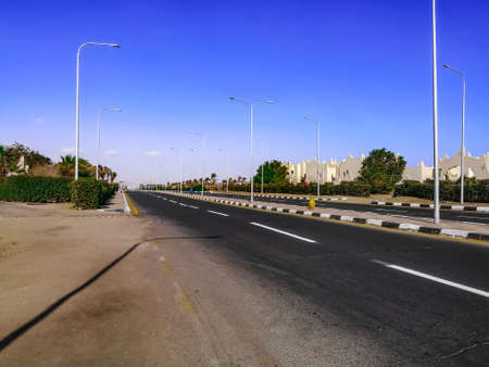 Empty city street with large jugs on the sidewalk in Sharm El Sheikh (Egypt). Cityscape of tropical...