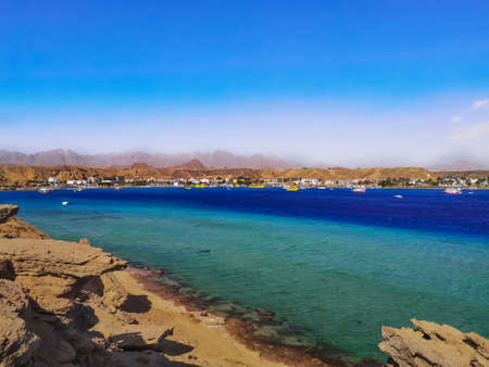 Wild Beach in Sharm El-Maya Bay in Sharm El Sheikh (Egypt). Beautiful sea panorama with turquoise-blue-azure water and the Sinai Mountains on the horizonの写真素材