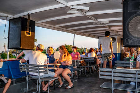 Kherson, Ukraine - July 22, 2020: People are resting on the deck of a motor ship in Kherson. Walk on a tourist boat along the Dnieper and Konka rivers in Kherson floodplainsのeditorial素材