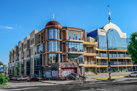 Kherson, Ukraine - July 22, 2020: Abandoned modern building of the shopping mall Suvorovsky in Kherson. Graffiti on the facade of a glass building in the city center. Urban vandalismのeditorial素材