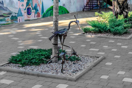 Kherson, Ukraine - July 22, 2020: Park sculptures of birds made of steel on a flower bed on Kanatna street in Kherson. Metal animals outside the kindergartenのeditorial素材