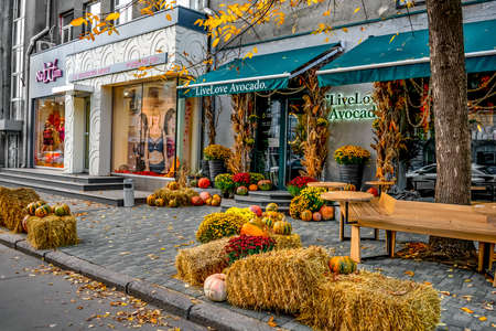 Kharkiv, Ukraine - October 20, 2020: Exterior design of the restaurant Live. Love. Avocado for Halloween in Kharkiv. Pumpkins, hay and autumn flowers on a city street near the entrance to a restaurantのeditorial素材