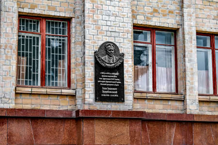 Kharkiv, Ukraine - October 20, 2020: Bas-relief in honor of Zalyubovsky Ilya Ivanovich on the wall of V.N. Karazin Kharkiv National University. Black granite slab with a portrait of a scientist and white text on the facade of the buildingのeditorial素材