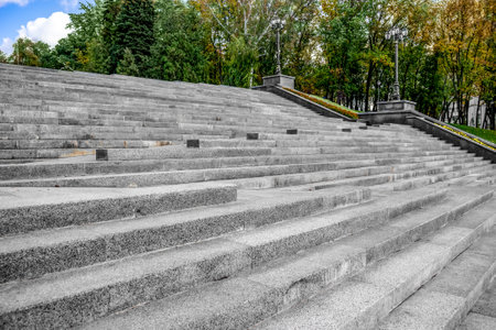 Staircase "Cascade" in Taras Shevchenko City Garden in Kharkiv (Ukraine). Bottom view of a stone steps against the background of an autumn parkの写真素材