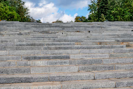 Bottom view of the Cascade stairs in Kharkiv, Ukraine. Granite steps on a background of blue sky and...