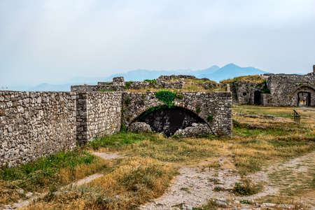 Ruins of ancient stone buildings in Shkoder Castle, Albania. Medieval stone walls among a...
