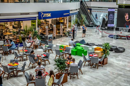 Tirana, Albania - June 21, 2021: People sit at tables in the cafeteria at Toptani Shopping Center in Tirana. Top view of the food court in the mallのeditorial素材