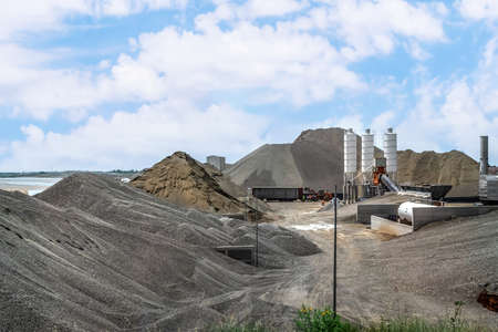 Piles of rubble and sand at a cement plant in Lezhe District of Albania. Building materials, machinery and equipment outdoorsの写真素材