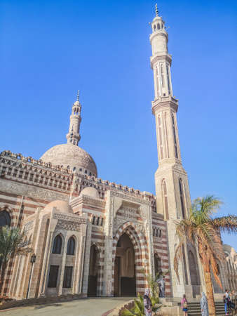 Sharm El Sheikh, Egypt - January 18, 2020: Side view of the Al Mustafa Mosque in Sharm El Sheikh. Striped facade and entrance to an Egyptian Muslim temple, verticalのeditorial素材