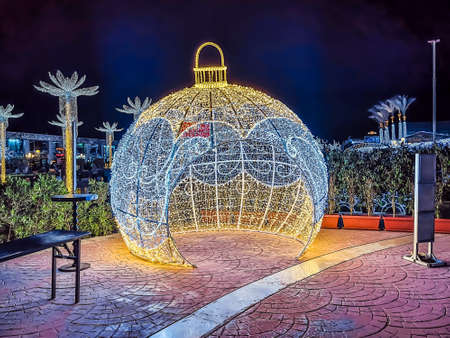 Sharm El Sheikh, Egypt - January 18, 2020: Luminous gazebo in the shape of a Christmas ball at Soho Square in Sharm El Sheikh at night, Egypt. Illuminated festive decorations on the city streetのeditorial素材