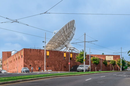 San Cristobal de La Laguna, Spain - November 24, 2021: View from Avenida de los Menceyes street to Museum of Science and the Cosmos. Road on the background of a building with a large radio telescopeのeditorial素材