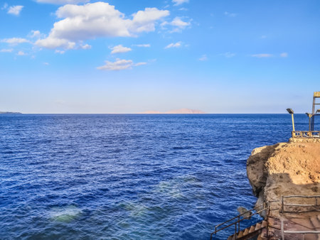 View from the beach in Sharm El Sheikh to Tiran Island in the Red Sea, Egypt. Tropical seascape with desert islets on the horizonの写真素材