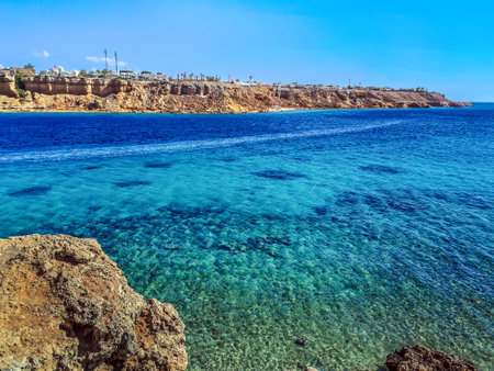 Top view from the cliff to the Red Sea in the Sharm el-Maya bay in Sharm El Sheikh, Egypt. Amazing seascape with azure water against desert cityscapeの写真素材
