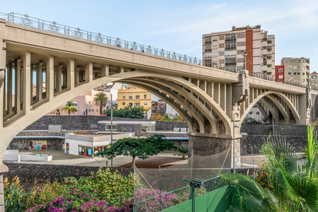 Santa Cruz de Tenerife, Spain - November 24, 2021: Arch Galceran Bridge over the Barranco de Santos in Santa Cruz de Tenerife. Modern cityscape of the capital of the Canary Islandsのeditorial素材