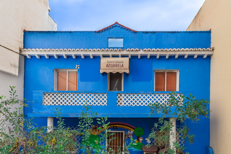 San Cristobal de La Laguna, Spain - November 24, 2021: Acuarela Watercolor Children Center on Avenida de los Menceyes street. Bright blue facade with balcony of a traditional Canarian buildingのeditorial素材