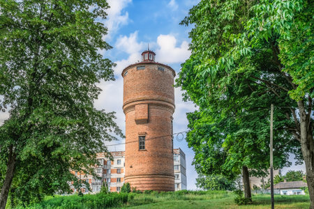 Old brick water tower near the Trostyanets central park, Sumy region, Ukraine. A round tall building...