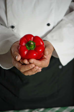 chef making an ecological and raw salad with Cheri tomatoes, peppers, onions, olive oil 