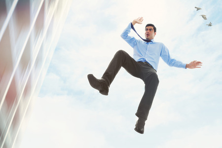 Stock image of businessman falling off a buildingの写真素材