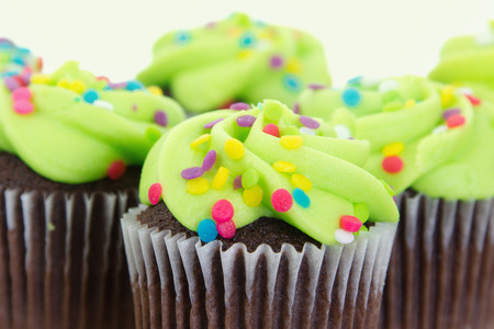 Stock image of arrangement of freshly baked and decorated green cupcakesの写真素材