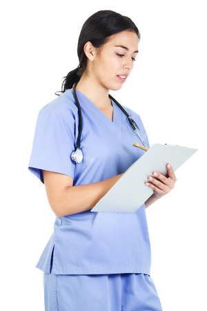 Stock image of a female healthcare worker writing on patient chart isolated on white backgroundの写真素材