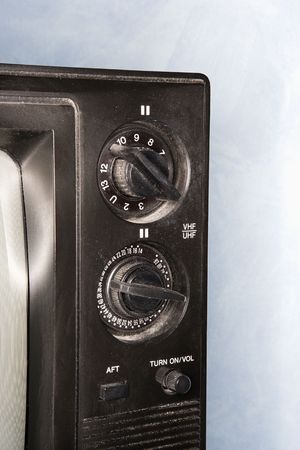 Close-up of old television set control panel.