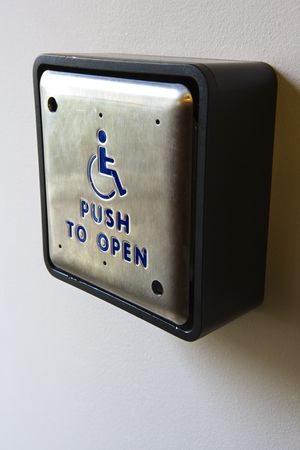 Metal door entrance button for physically challenged or handicapped people.の写真素材