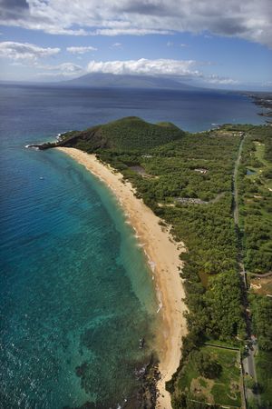 Aerial of coastline with sandy beach and Pacific ocean in Maui, Hawaii.