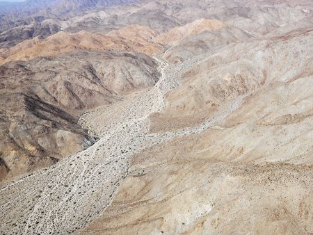 Aerial view of torrid California desert with rocky landforms.の写真素材
