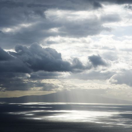 View of island in Pacific ocean with clouds from Maui, Hawaii.の写真素材