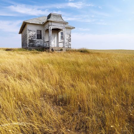 Weathered abandoned building in remote grassland.の写真素材