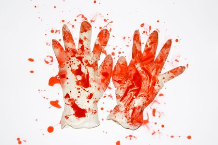 Pair of rubber gloves with blood splattered on them.の写真素材
